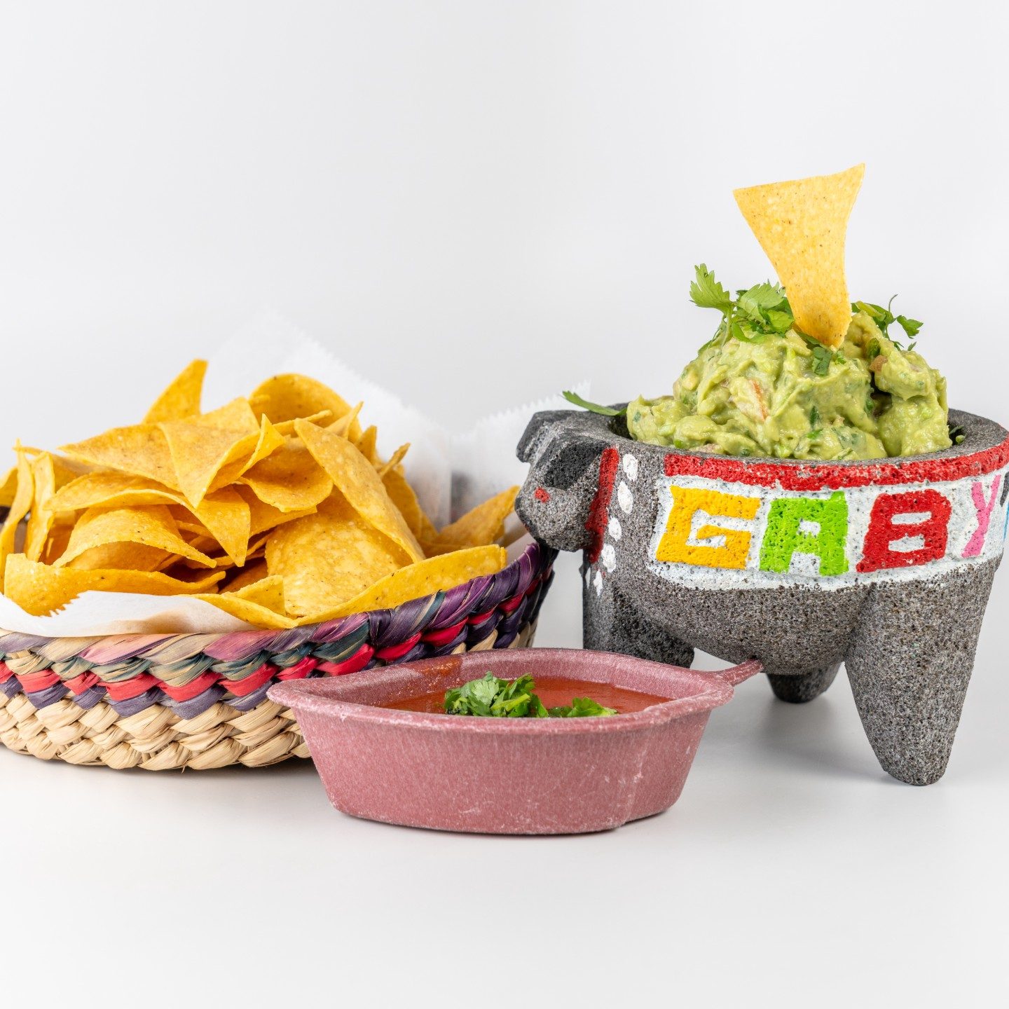 Guacamole served in a Gaby’s molcajete with tortilla chips and salsa