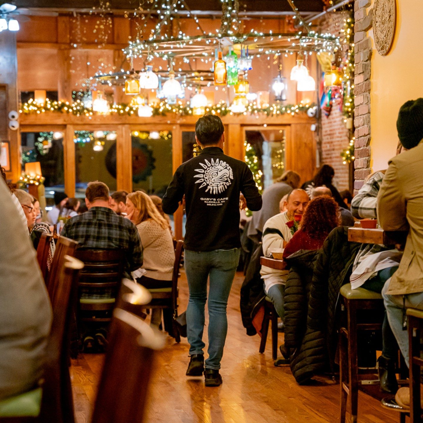 A busy evening in the Gaby’s Cafe dining room under string lights